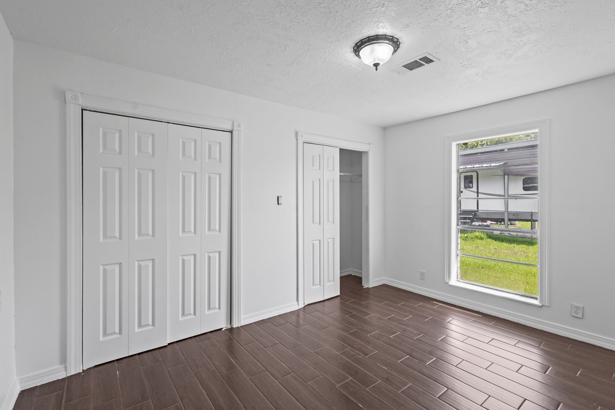 6281 25th Street Groves, TX 77619 - Photo 11 of 26 an empty room with window and a ceiling fan