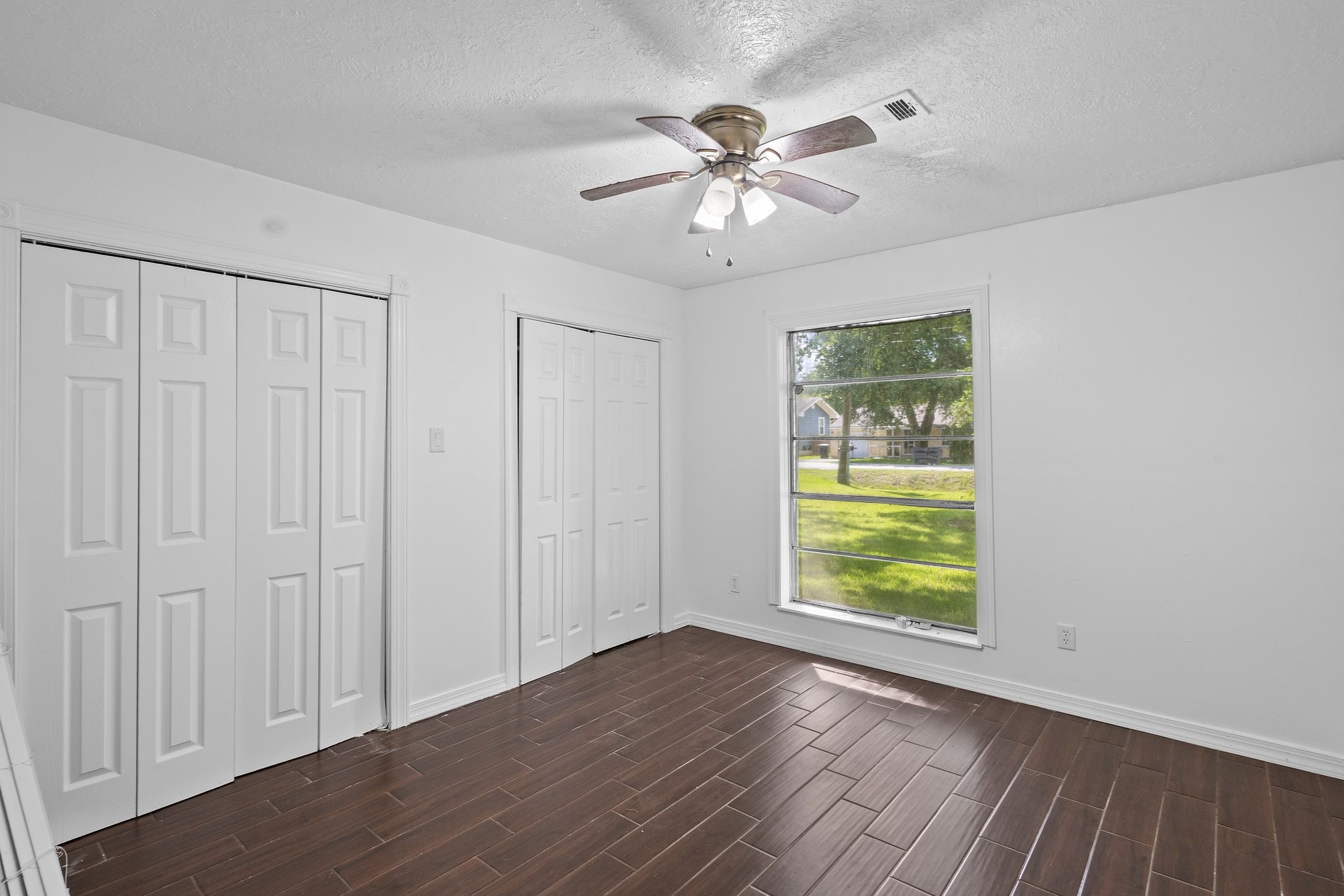6281 25th Street Groves, TX 77619 - Photo 13 of 26 a view of an empty room with a window and wooden floor