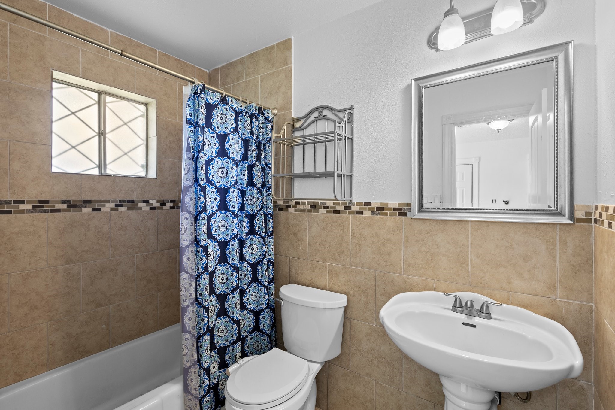 6281 25th Street Groves, TX 77619 - Photo 14 of 26 a bathroom with a sink a toilet and a mirror