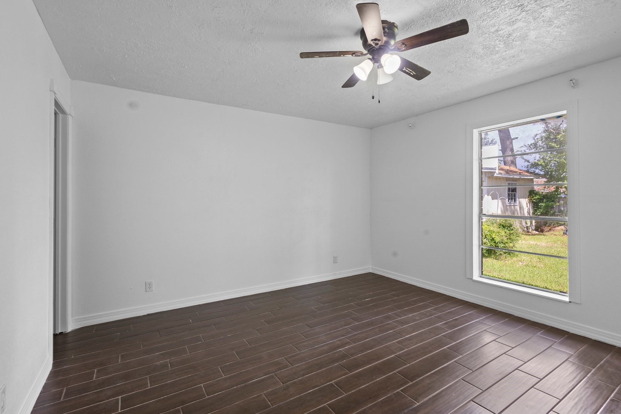 6281 25th Street Groves, TX 77619 - Photo 17 of 26 wooden floor in an empty room with a window