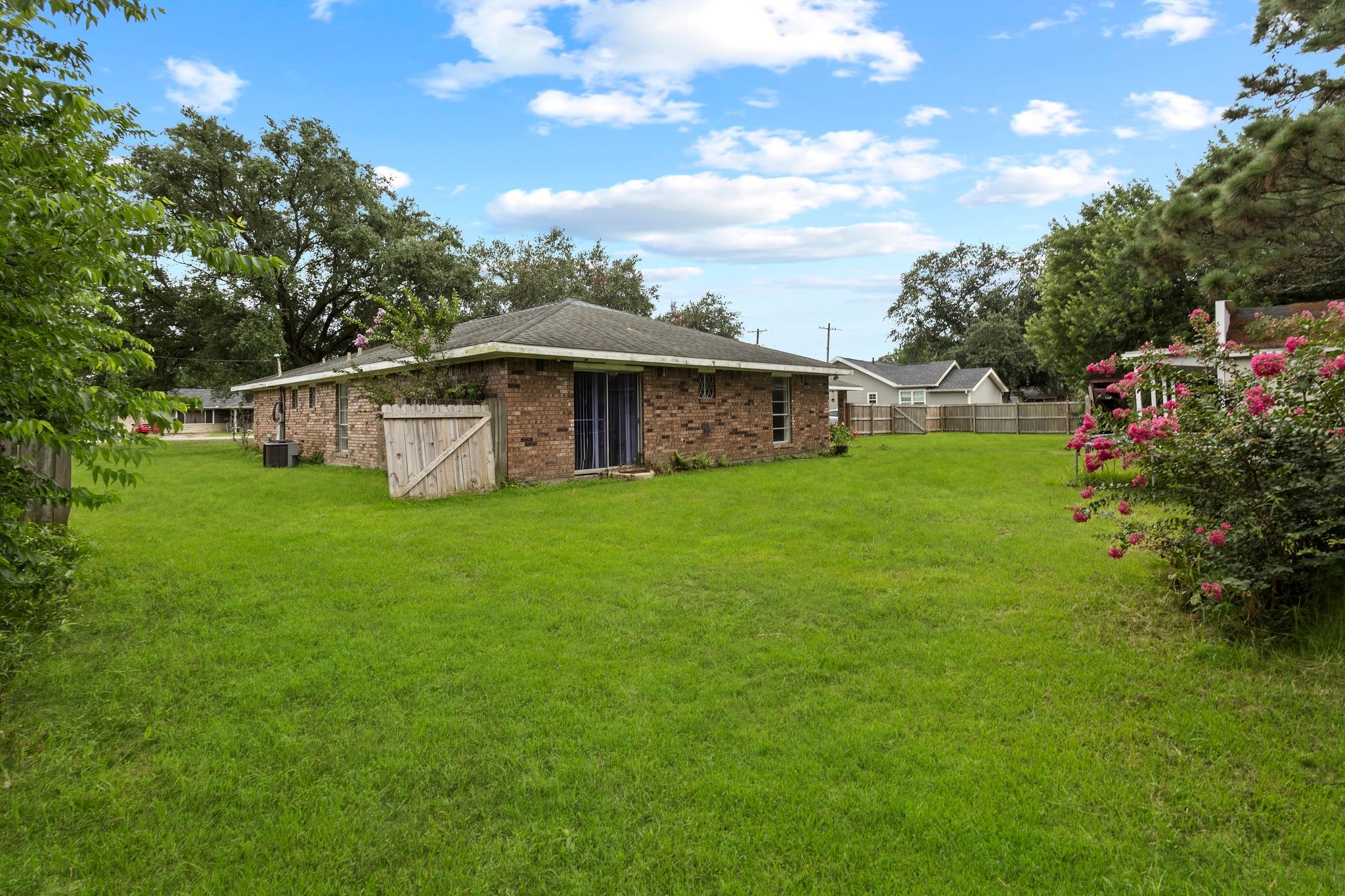 6281 25th Street Groves, TX 77619 - Photo 21 of 26 a view of a house with a yard deck and sitting area