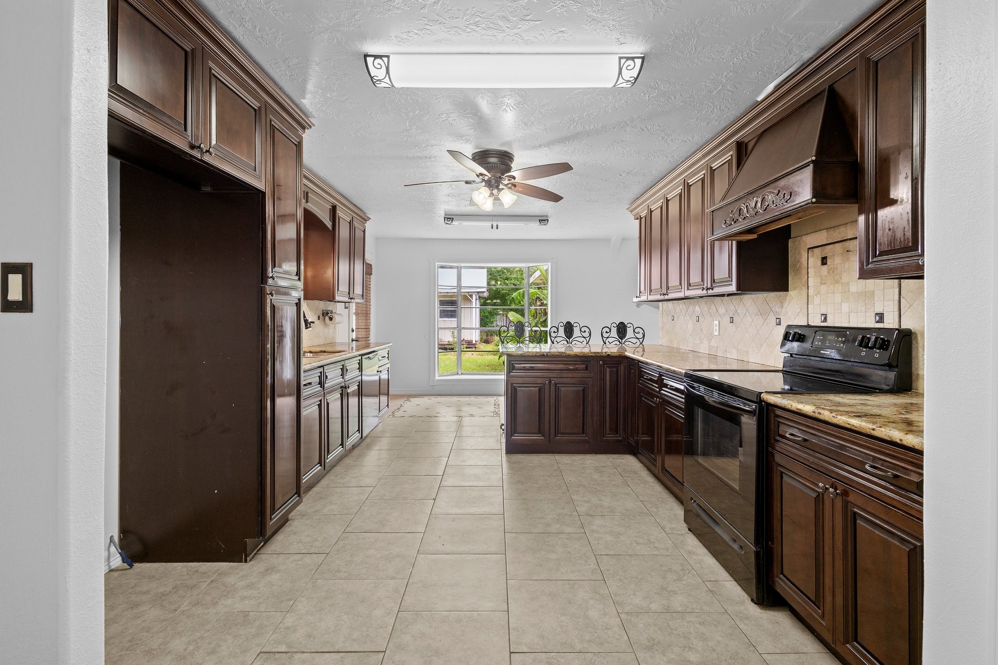 6281 25th Street Groves, TX 77619 - Photo 5 of 26 a kitchen with stainless steel appliances a sink stove and cabinets
