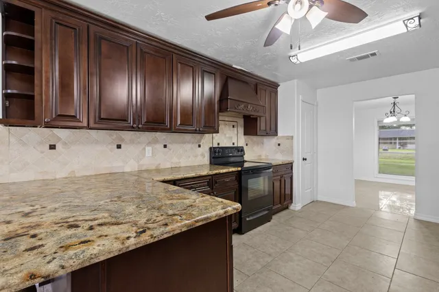 a view of kitchen with granite countertop window