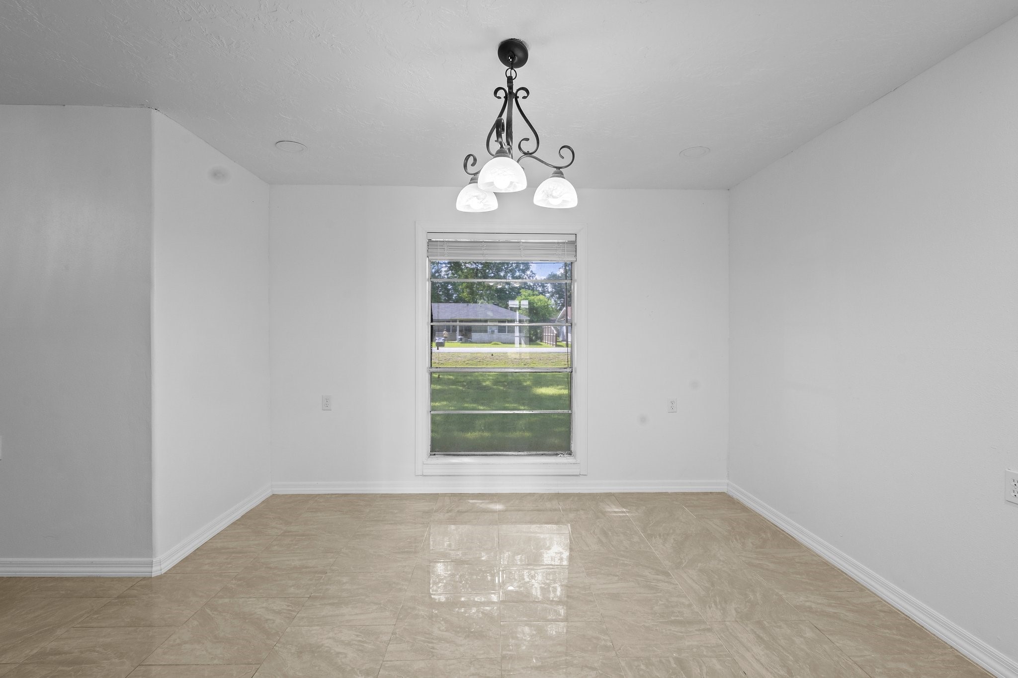 6281 25th Street Groves, TX 77619 - Photo 8 of 26 a view of a chandelier fan and wooden floor in a room