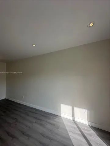 a view of an empty room and a window