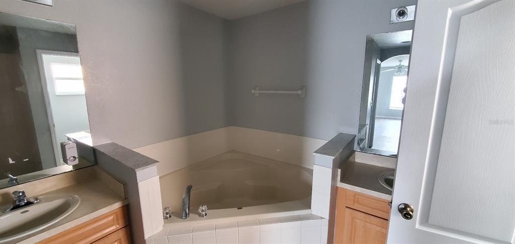 1757 Pompano Drive Kissimmee, FL 34759 - Photo 11 of 14 a bathroom with a bathtub and shower