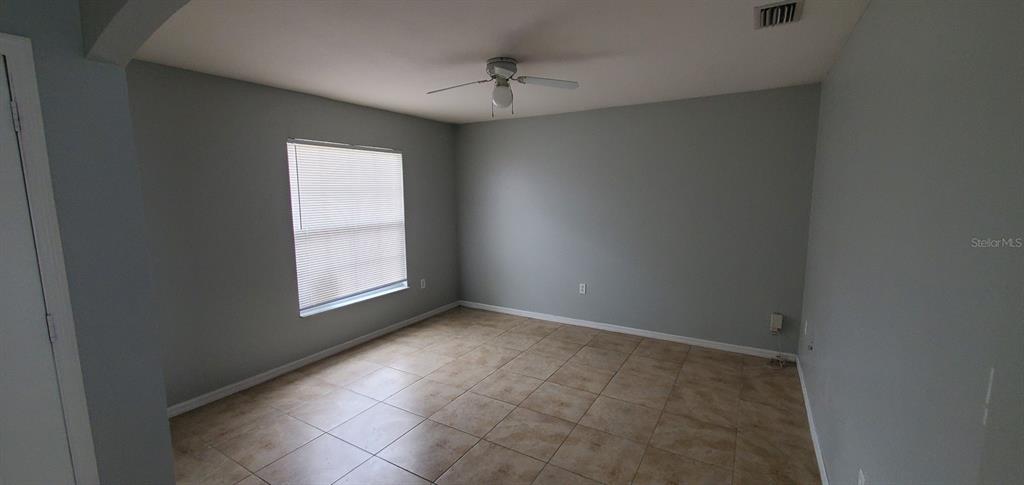 1757 Pompano Drive Kissimmee, FL 34759 - Photo 7 of 14 an empty room with a window