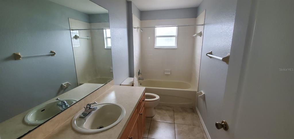 1757 Pompano Drive Kissimmee, FL 34759 - Photo 8 of 14 a bathroom with a sink a toilet and shower