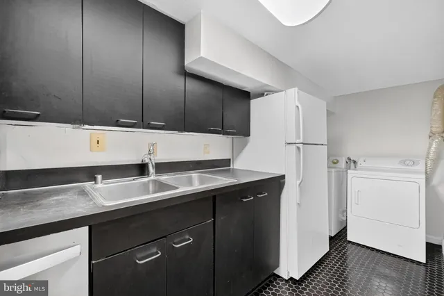 a kitchen with a sink and a refrigerator