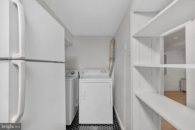 a view of storage and utility room with washer and dryer