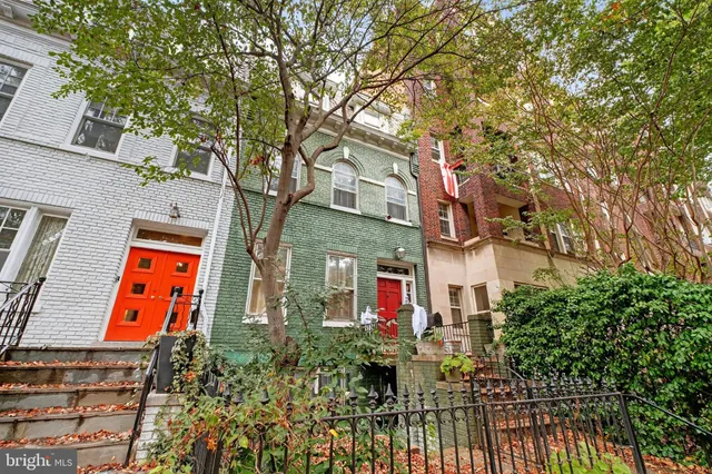 front view of house with large trees
