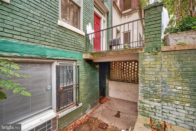 a view of a brick house with a large door