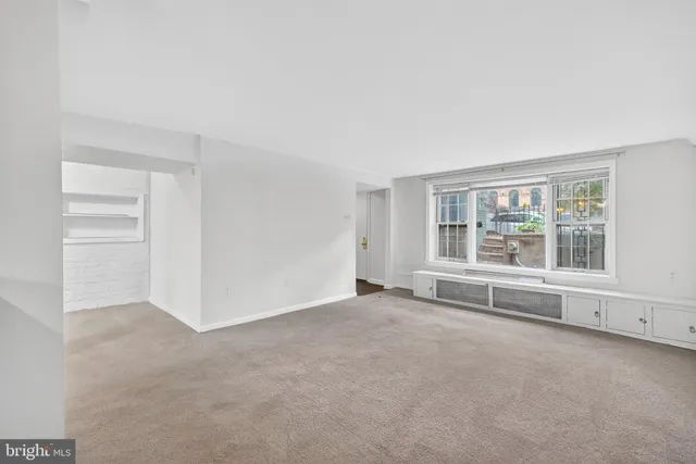 an empty room with a empty space and windows