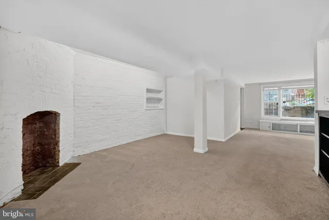 a view of an empty room with a fireplace