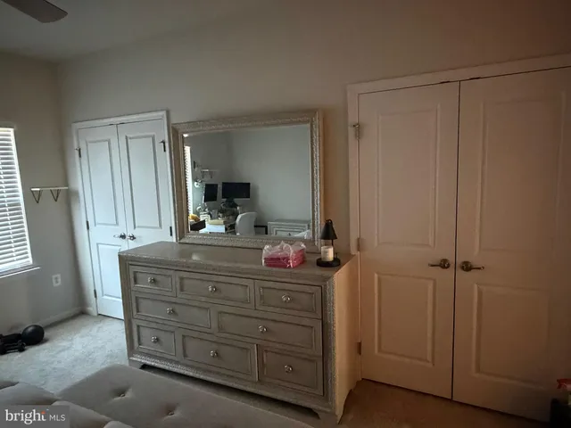 a bedroom with a bed couch and window