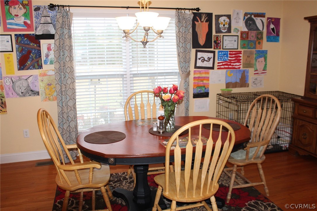 634 Holman Mill Road Farmville, VA 23901 - Photo 14 of 43 a view of a dining room with furniture and wooden floor