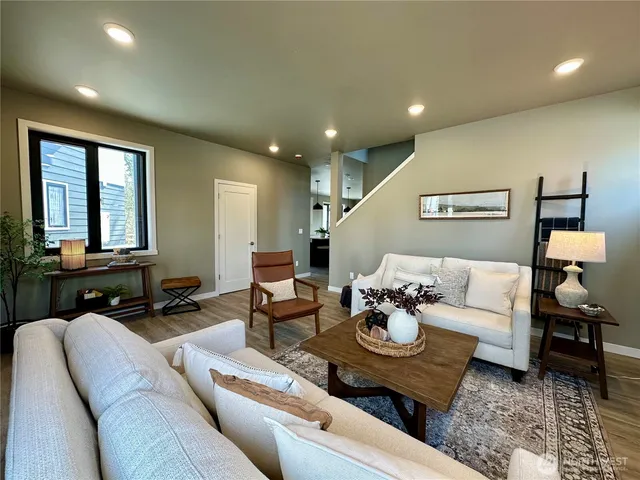a living room with furniture and kitchen view