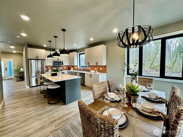 a kitchen with stainless steel appliances granite countertop a sink and a stove