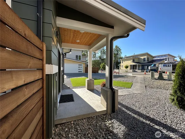 a view of a house with a yard and sitting area