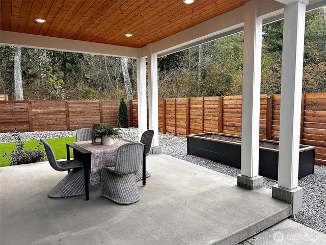 a view of a house with backyard and porch