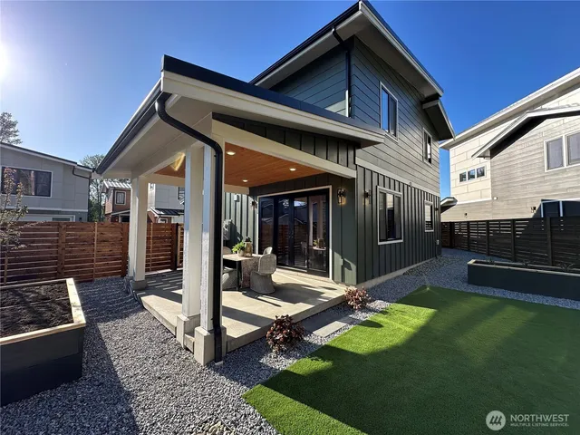 a kitchen with granite countertop a stove a sink a dining table and chairs