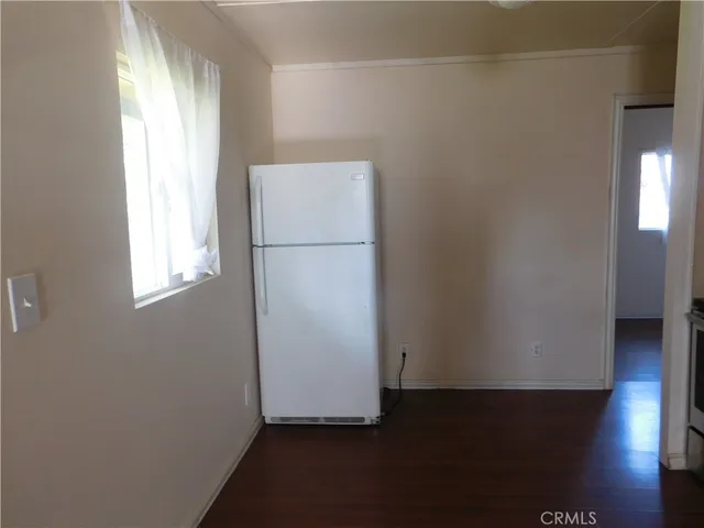a view of utility room with closet and wooden floor