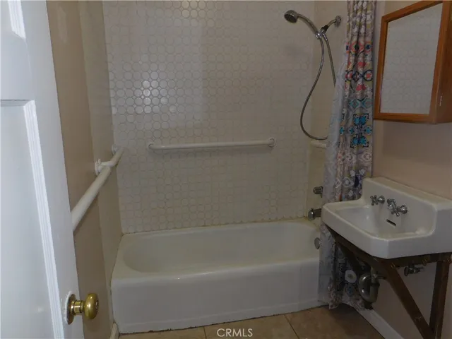 a bathroom with a sink a bath tub and a shower