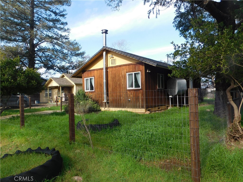 15868 Main Street Middletown, CA 95461 - Photo 2 of 16 a front view of house with a garden and patio