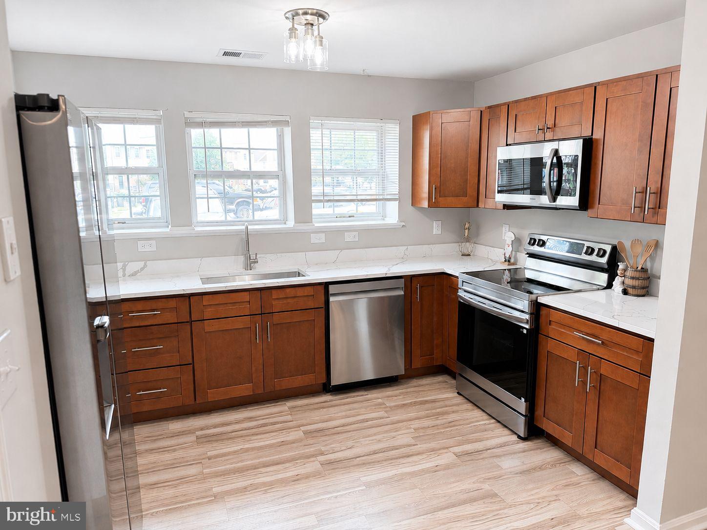 4119 Applegate Court, Unit 9 Suitland, MD 20746 - Photo 2 of 15 a kitchen with stainless steel appliances granite countertop a sink stove and microwave