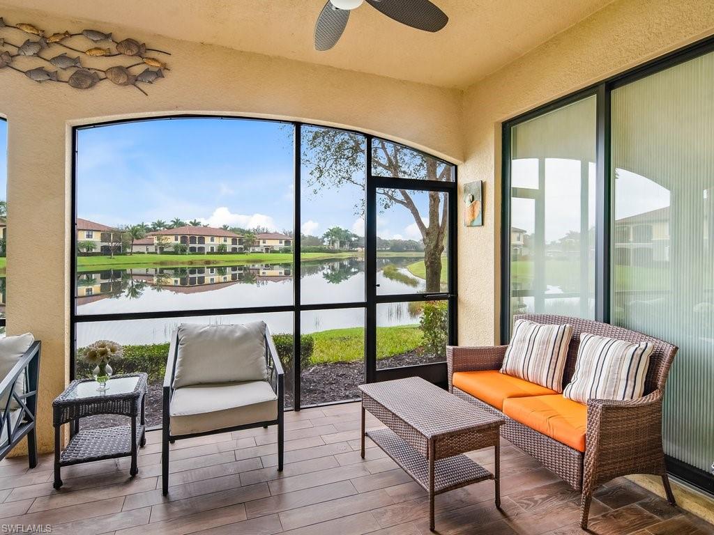 9118 Prima Way, Unit 101 Naples, FL 34113 - Photo 20 of 22 a balcony with furniture and a potted plant
