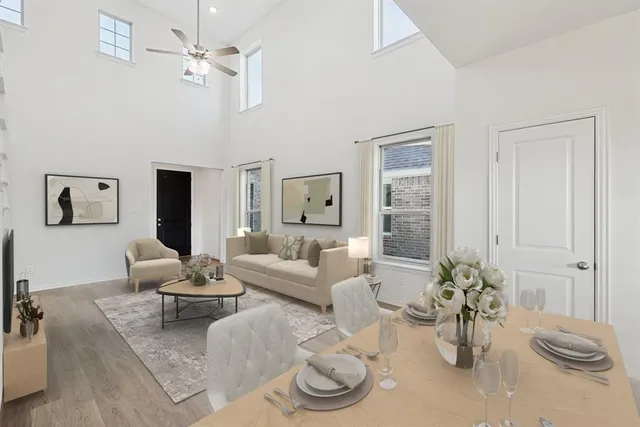 a living room with furniture potted plant and a chandelier