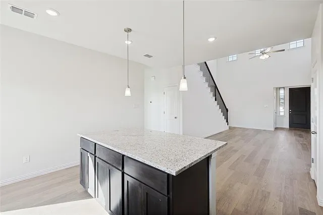 a kitchen with a counter top space and wooden floor