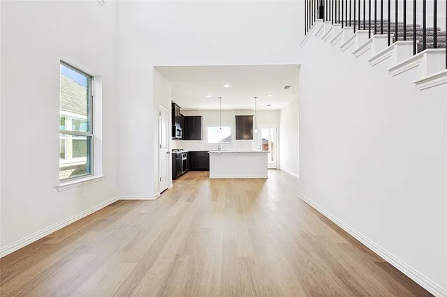 a view of open kitchen with wooden floor and electronic appliances