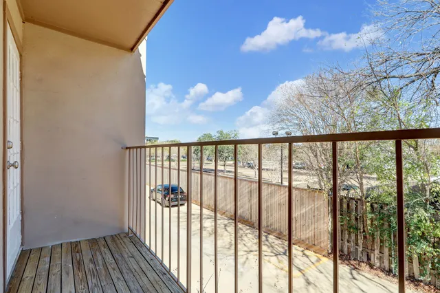 a view of a balcony with wooden floor