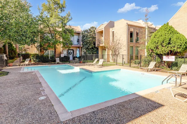 a view of a building with cars parked