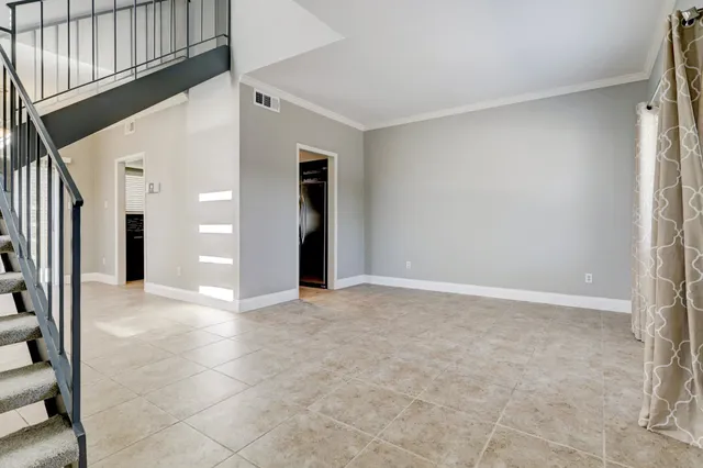 an empty room with windows and entrance