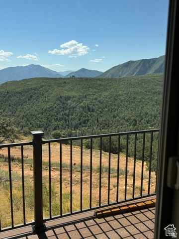 6909 East Spring Drive, Unit 19 Springville, UT 84663 - Photo 15 of 118 Outdoor decking with composite wood-finish material and black metal railing, offering expansive mountainous terrain and distant tree lines