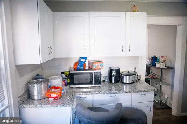a kitchen with stainless steel appliances granite countertop a sink and cabinets