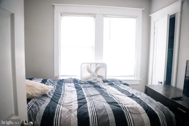 a bed sitting in a bedroom next to a window