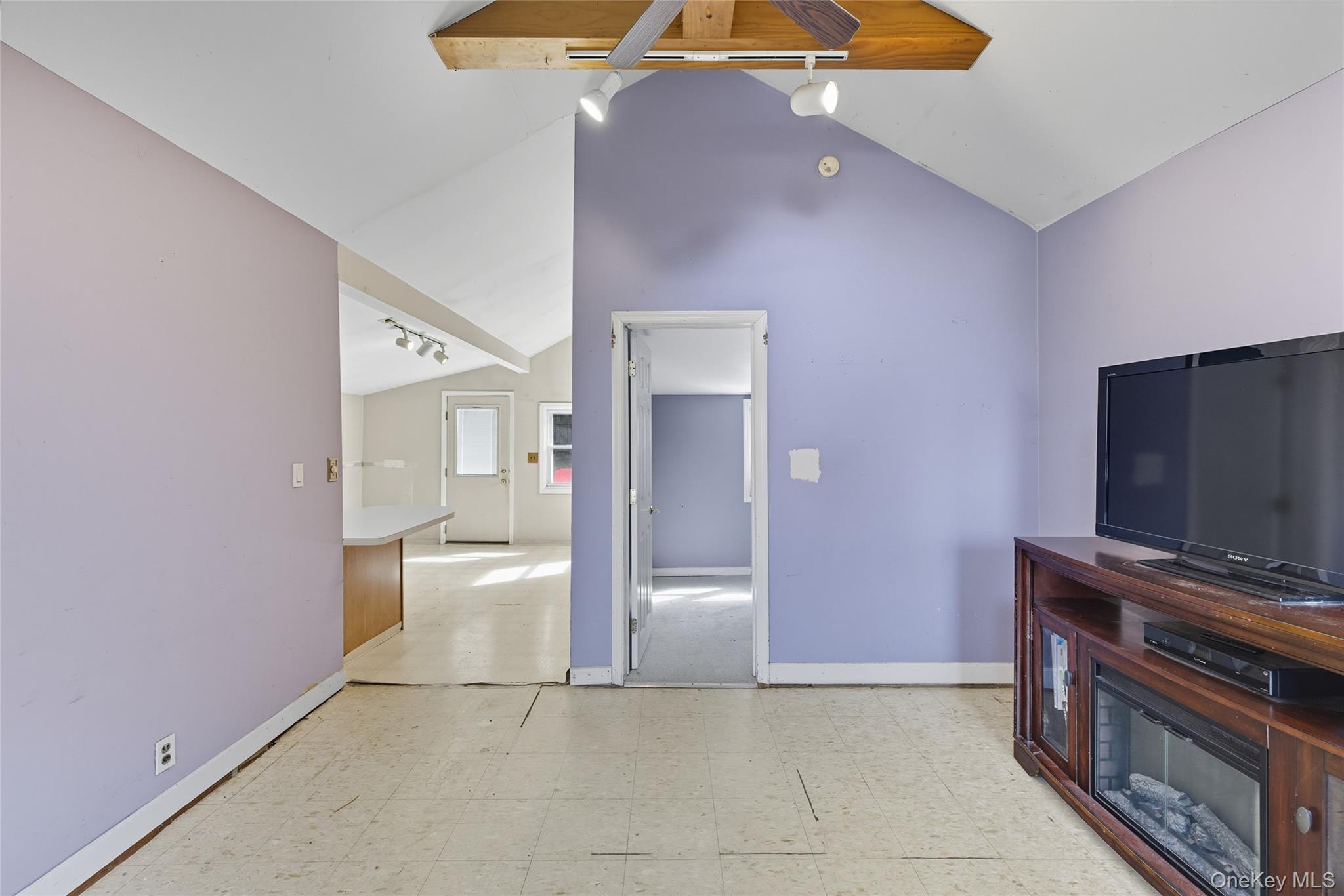 13 Darien Road Carmel, NY 10512 - Photo 5 of 17 a view of an empty room with a fireplace and a chandelier