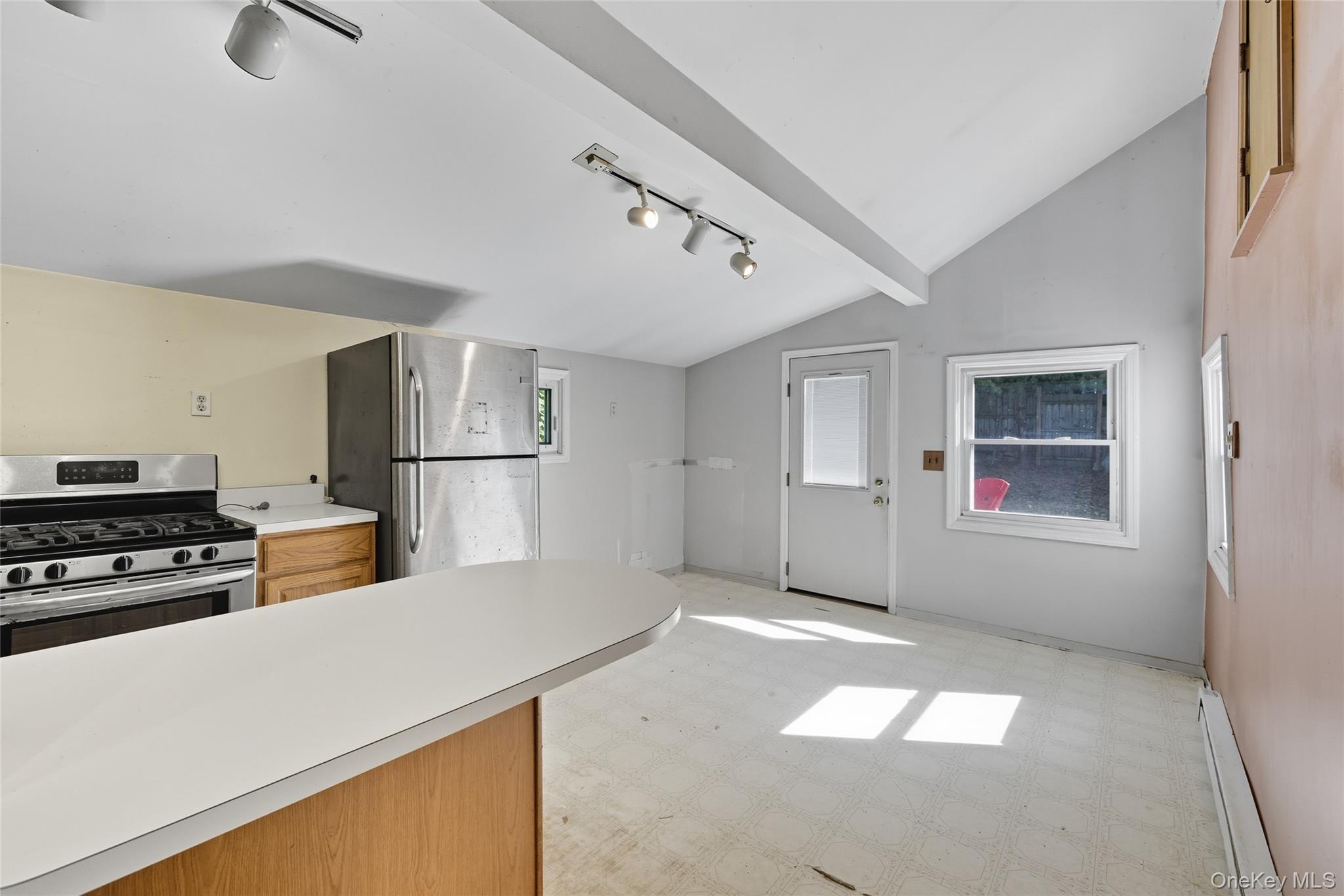 13 Darien Road Carmel, NY 10512 - Photo 9 of 17 a kitchen with a refrigerator and white cabinets