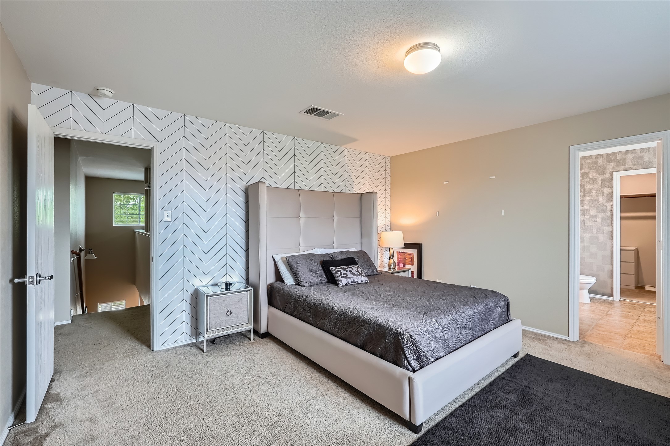 18021 Prairie Verbena Lane Elgin, TX 78621 - Photo 19 of 33 A striking accent wall provides a vibrant backdrop in this comfortable bedroom.