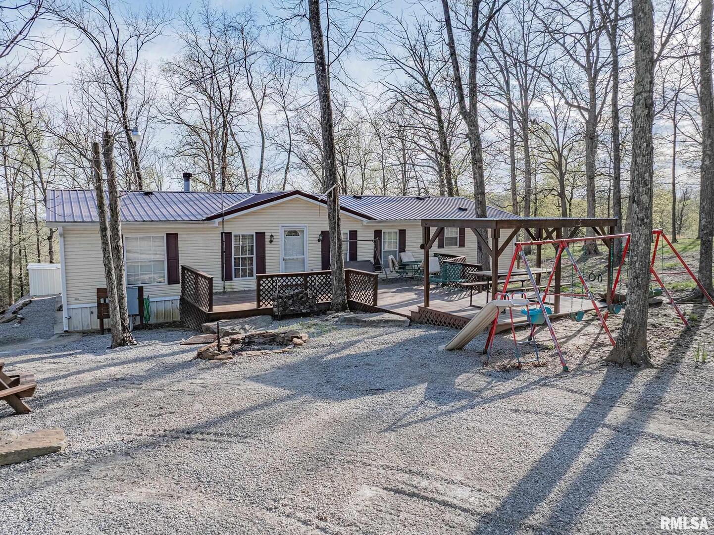 565 Dutton Chapel Road Herod, IL 62947 - Photo 8 of 54 a small house with a bench and trees