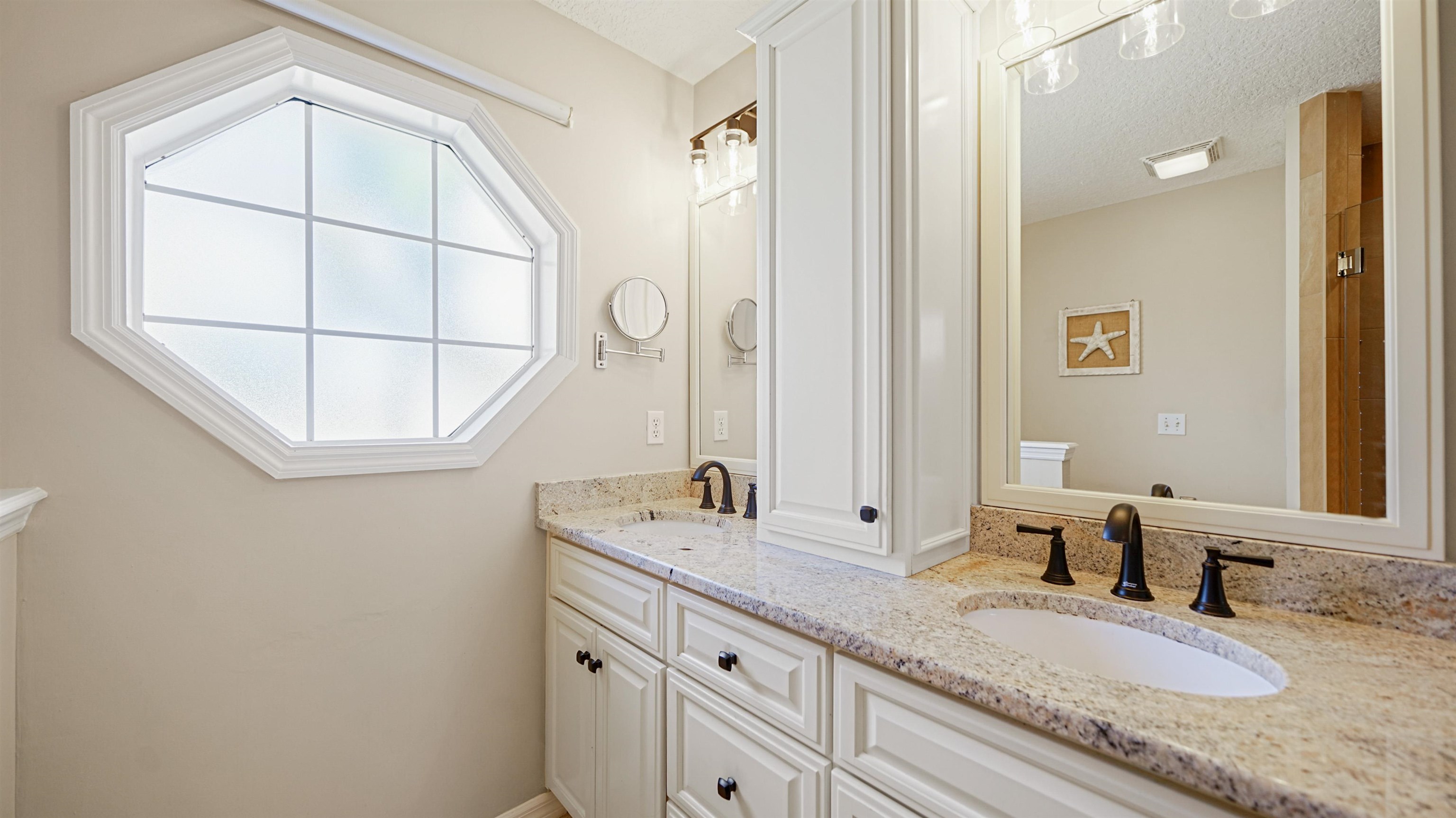 5324 5th Street St. Augustine, FL 32080 - Photo 23 of 49 a bathroom with a granite countertop sink and a mirror