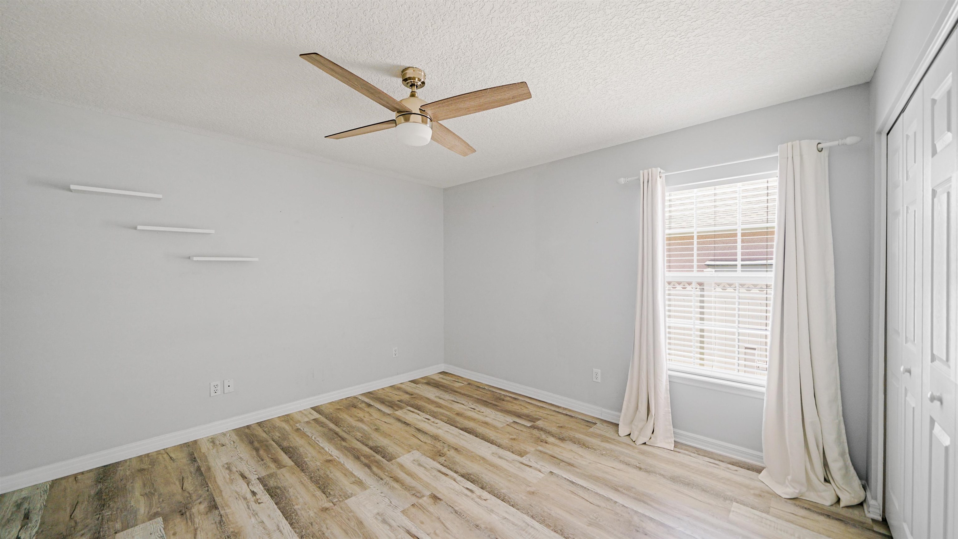 5324 5th Street St. Augustine, FL 32080 - Photo 25 of 49 a view of empty room with wooden floor and fan