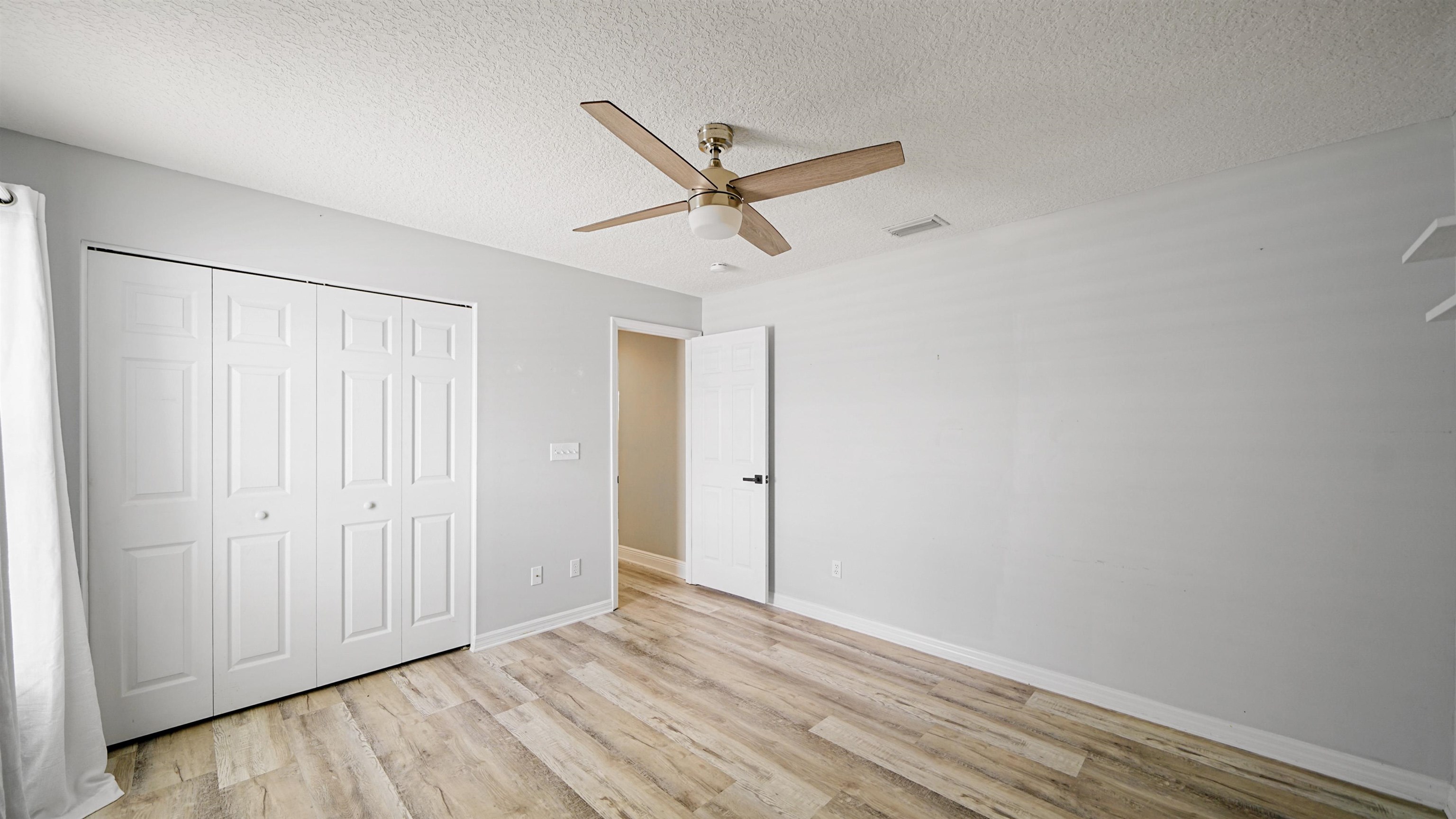 5324 5th Street St. Augustine, FL 32080 - Photo 26 of 49 a view of a room with wooden floor and a ceiling fan