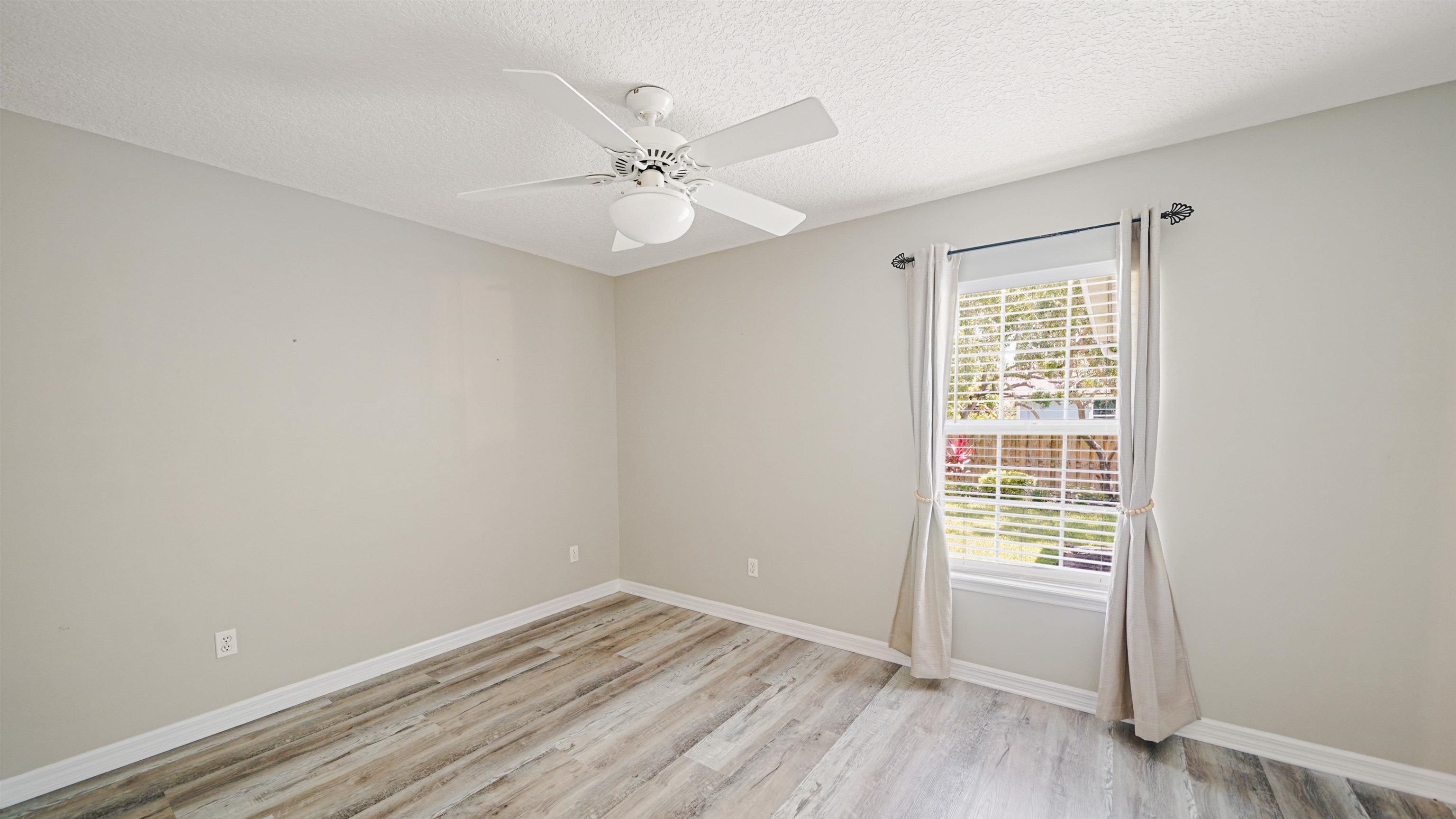 5324 5th Street St. Augustine, FL 32080 - Photo 28 of 49 wooden floor in an empty room with a window