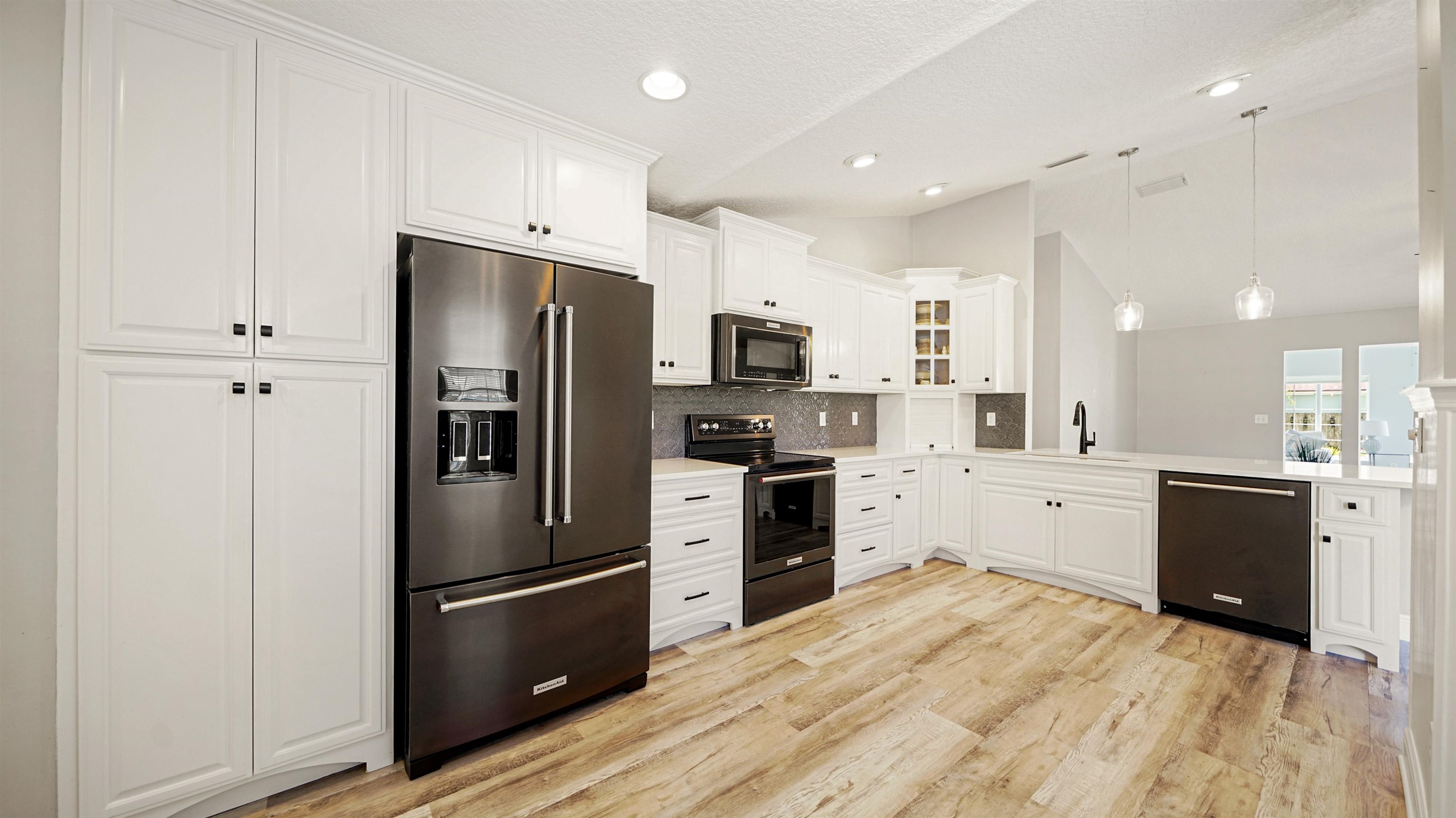 5324 5th Street St. Augustine, FL 32080 - Photo 7 of 49 a kitchen with a refrigerator stove and sink