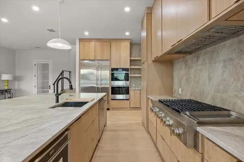 a kitchen with granite countertop a stove and a sink