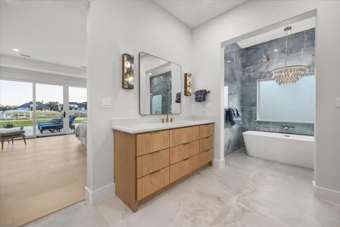 a bathroom with a tub sink and mirror